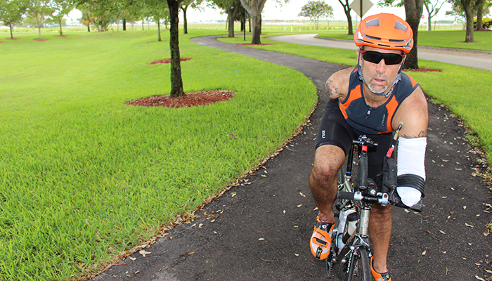 Bilateral amputee Hector Picard rides his bike in a race.