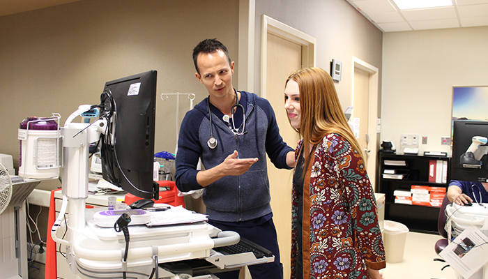 An Encompass Health nurse reviews the ReACT dashboard with a case manager.