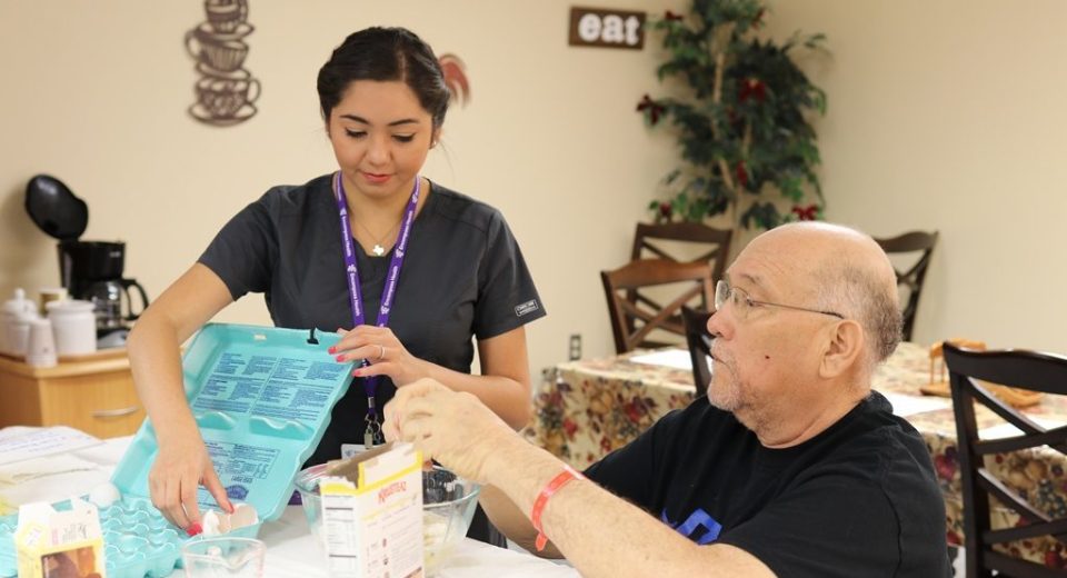 An Encompass Health OT helps a patient prepare a meal