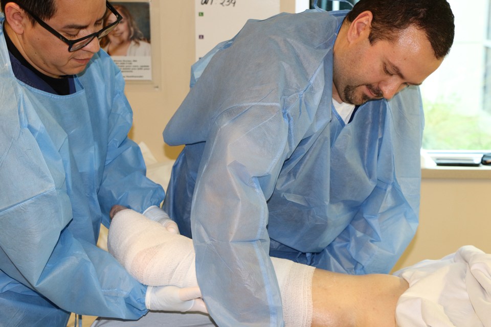 An Encompass Health nurse wraps a patient's wound.