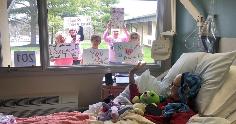 Brenda Stover's friends surprise her outside her hospital window with signs of encouragement