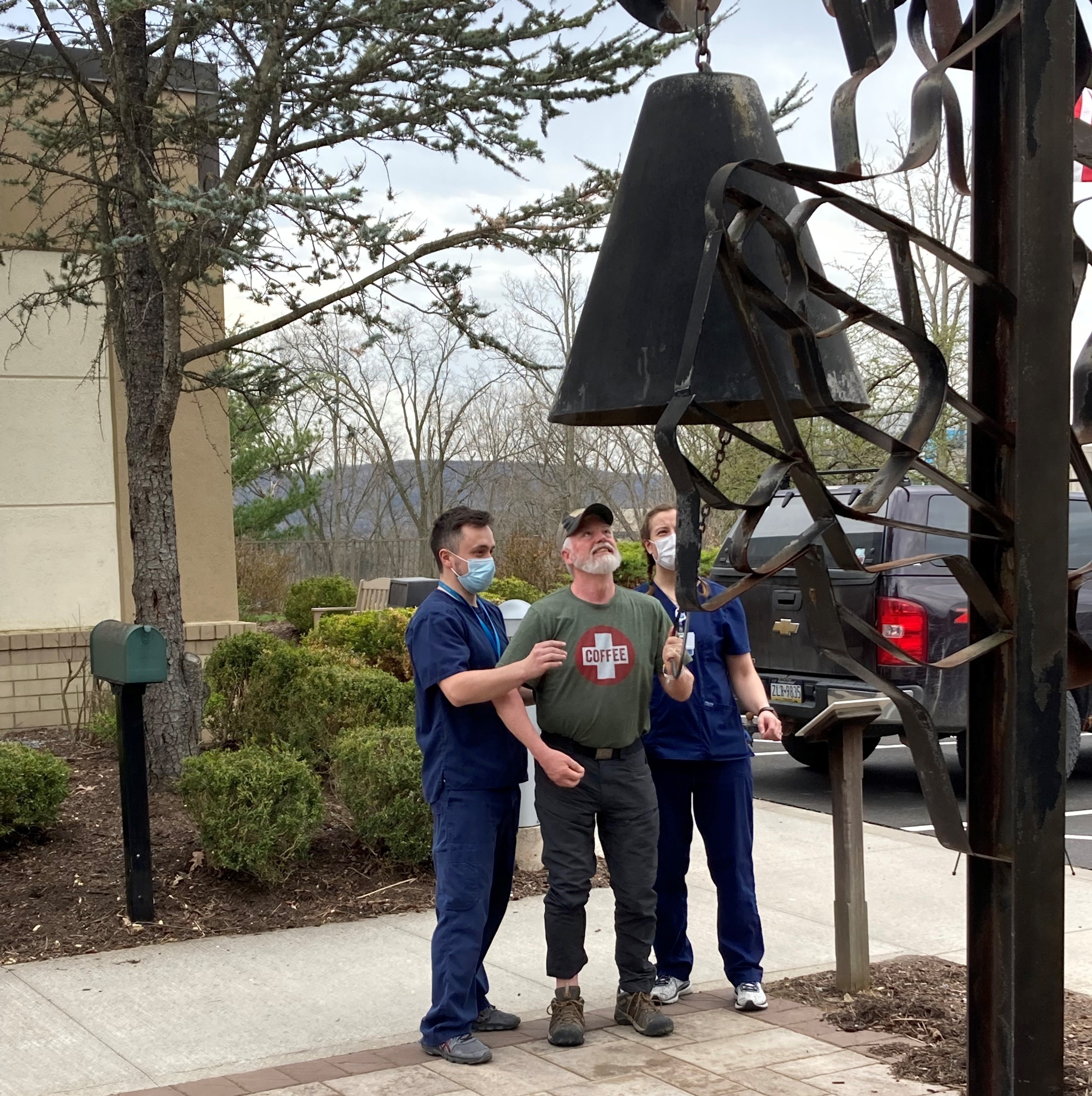 Tony rings the bell outside Geisinger Encompass Health Rehabilitation Hospital signaling his discharge to return home.
