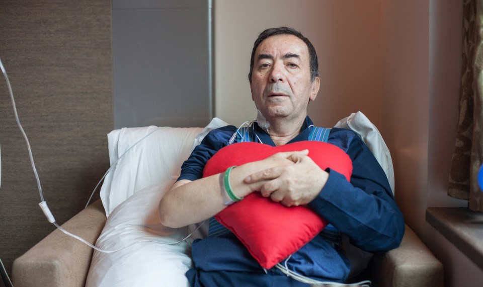 patient clutching heart surgery pillow to chest